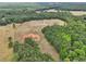 Aerial view showcasing a house, barn, and surrounding land at 615 Henderson Mill Rd, Covington, GA 30014