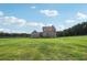 Spacious backyard with large grassy area and home at 615 Henderson Mill Rd, Covington, GA 30014