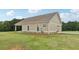 Tan house with stone accents and a covered porch, situated on a spacious lot at 615 Henderson Mill Rd, Covington, GA 30014