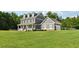 Two-story house with gray siding, stone accents, and a large front yard at 615 Henderson Mill Rd, Covington, GA 30014