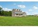 Two-story house with gray siding, stone accents, and a large front yard at 615 Henderson Mill Rd, Covington, GA 30014