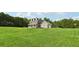 Two-story house with gray siding, stone accents, and a large front yard at 615 Henderson Mill Rd, Covington, GA 30014