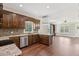 Open kitchen with island, stainless steel appliances, and hardwood floors at 615 Henderson Mill Rd, Covington, GA 30014