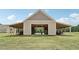 Tan colored workshop with covered parking and open doors at 615 Henderson Mill Rd, Covington, GA 30014