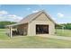 Tan colored workshop with covered parking and open doors at 615 Henderson Mill Rd, Covington, GA 30014