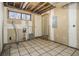 Unfinished basement laundry area with tiled floor at 1875 Abbie Ln, Jonesboro, GA 30236
