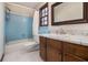 Small bathroom with blue tile, a shower/tub combo, and wood vanity at 1875 Abbie Ln, Jonesboro, GA 30236