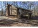 Side of Ranch home with green metal roof and wood siding at 1875 Abbie Ln, Jonesboro, GA 30236