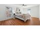 Bright bedroom with white walls, hardwood floors, and stylish ceiling fan at 6851 Roswell Rd # N-20, Sandy Springs, GA 30328