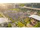 Aerial view of a large community gathering with a stage, tables, and ample green space at 6851 Roswell Rd # N-20, Sandy Springs, GA 30328