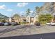 Condo building exterior with parking lot and landscaping at 6851 Roswell Rd # N-20, Sandy Springs, GA 30328