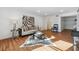Spacious living room with hardwood floors, zebra-print rug, and stylish furniture at 6851 Roswell Rd # N-20, Sandy Springs, GA 30328
