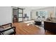 Bright living room featuring hardwood floors, bay window, and modern sliding barn door at 6851 Roswell Rd # N-20, Sandy Springs, GA 30328