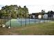 Well-maintained tennis courts with lighting, surrounded by lush greenery, for an active lifestyle at 6851 Roswell Rd # N-20, Sandy Springs, GA 30328