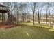 Spacious backyard with steps leading up to a deck and a wooded view at 9776 Spyglass Dr, Villa Rica, GA 30180