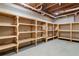 Unfinished basement with built-in wooden shelving units for storage at 9776 Spyglass Dr, Villa Rica, GA 30180