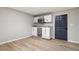 Basement wet bar with white cabinets, granite countertops, and mini-fridge at 9776 Spyglass Dr, Villa Rica, GA 30180