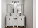Double vanity bathroom with modern white cabinets and black fixtures at 9776 Spyglass Dr, Villa Rica, GA 30180