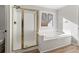 Clean bathroom with a large soaking tub, shower, and window at 9776 Spyglass Dr, Villa Rica, GA 30180