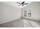 Well-lit bedroom featuring grey carpet and ceiling fan at 9776 Spyglass Dr, Villa Rica, GA 30180