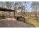 Wooden deck with pergola, ceiling fan, and wooded backyard views at 9776 Spyglass Dr, Villa Rica, GA 30180