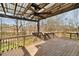 Wooden deck with pergola, ceiling fan, and wooded backyard views at 9776 Spyglass Dr, Villa Rica, GA 30180