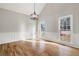 Formal dining room with hardwood floors, wainscoting, and chandelier at 9776 Spyglass Dr, Villa Rica, GA 30180