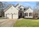 Charming home featuring a two-car garage and an inviting front porch with stone accents at 9776 Spyglass Dr, Villa Rica, GA 30180