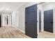 Basement hallway with grey doors and light brown vinyl flooring at 9776 Spyglass Dr, Villa Rica, GA 30180