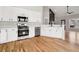 Modern kitchen featuring white cabinets, stainless steel appliances, and hardwood floors at 9776 Spyglass Dr, Villa Rica, GA 30180