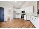 Bright kitchen boasts white cabinets, stainless steel appliances, and hardwood floors at 9776 Spyglass Dr, Villa Rica, GA 30180