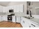 Modern kitchen with white cabinets, stainless steel appliances and granite countertops at 9776 Spyglass Dr, Villa Rica, GA 30180