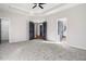 Bright main bedroom with carpet, ceiling fan, and access to other rooms at 9776 Spyglass Dr, Villa Rica, GA 30180