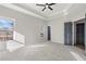 Sunlit main bedroom featuring carpet, ceiling fan, and multiple windows at 9776 Spyglass Dr, Villa Rica, GA 30180