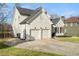 Home exterior featuring a two-car garage and well-maintained lawn at 9776 Spyglass Dr, Villa Rica, GA 30180
