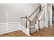 Elegant wooden staircase with gray carpeting and white railing at 9776 Spyglass Dr, Villa Rica, GA 30180