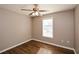 Bright bedroom featuring wood floors and a ceiling fan at 202 Greentree Trl, Temple, GA 30179