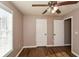 Bright bedroom with ceiling fan and double closets at 202 Greentree Trl, Temple, GA 30179