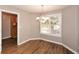 Bright dining room features hardwood floors, a chandelier, and a view to the backyard at 202 Greentree Trl, Temple, GA 30179