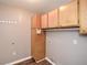 Laundry room with upper cabinets and a hanging rod at 202 Greentree Trl, Temple, GA 30179