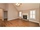 Living room with hardwood floors, a stone fireplace and ceiling fan at 202 Greentree Trl, Temple, GA 30179