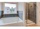 Bathroom featuring garden tub and shower at 70 Barge Ln, Covington, GA 30016