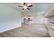 Spacious living area with hardwood floors, kitchen view, and ceiling fan at 70 Barge Ln, Covington, GA 30016