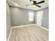 Large bedroom with gray walls, ceiling fan, and light gray vinyl flooring at 755 Tanner Rd, Dacula, GA 30019