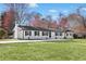 Charming one story home featuring a black roof, freshly painted exterior, and a lush green lawn at 755 Tanner Rd, Dacula, GA 30019