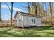 Backyard storage shed with double doors and windows, surrounded by greenery and natural light at 755 Tanner Rd, Dacula, GA 30019