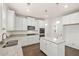 Modern kitchen with white cabinets, granite counters and island at 13490 Whitman Ln, Covington, GA 30014