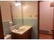 Small bathroom with wood vanity and neutral tile at 4890 Prince Se Rd, Smyrna, GA 30082