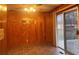 Dining area with wood paneling and sliding door to deck at 4890 Prince Se Rd, Smyrna, GA 30082