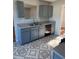 Kitchen with gray cabinets, tile floor, and stainless steel dishwasher at 128 Waters Edge Way, Fayetteville, GA 30215